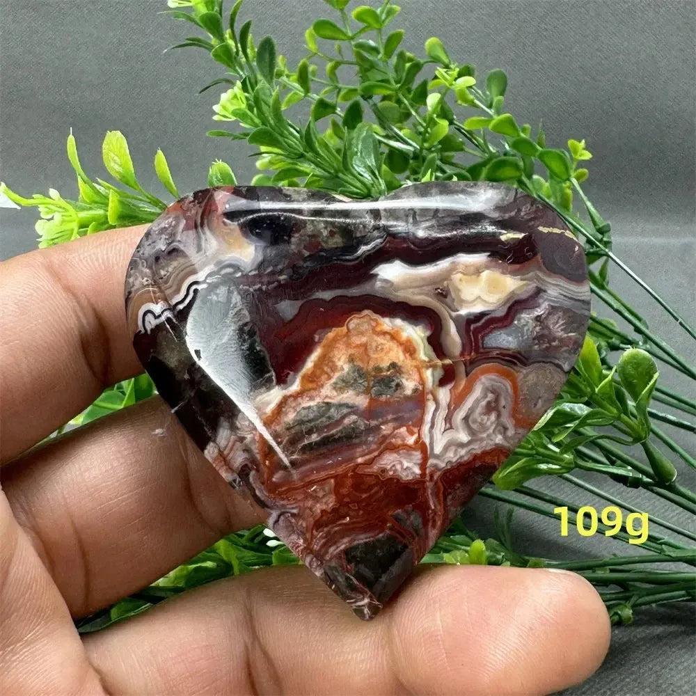 Mexican Agate Crystal Freeform: Polished heart-shaped stone with warm oranges, deep reds, and creamy whites.