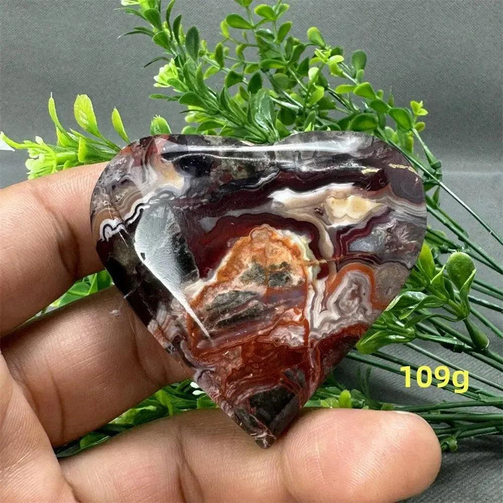 Mexican Agate Crystal Freeform: Polished heart-shaped stone with warm oranges, deep reds, and creamy whites.