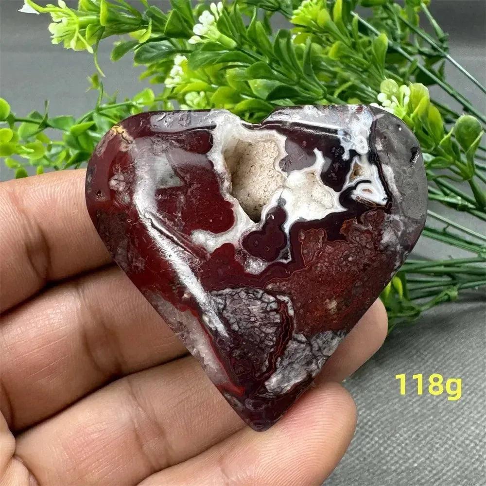 Mesmerizing Mexican Agate Crystal Freeform, a heart-shaped stone with rich reds, whites, and earthy browns, weighing 118g.