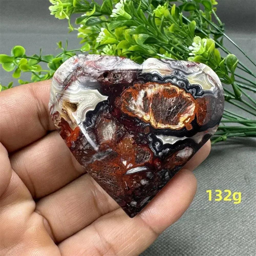 Mesmerizing Mexican Agate heart, 132g, with warm oranges, deep reds, creamy whites, and earthy browns. Strength and grounding.