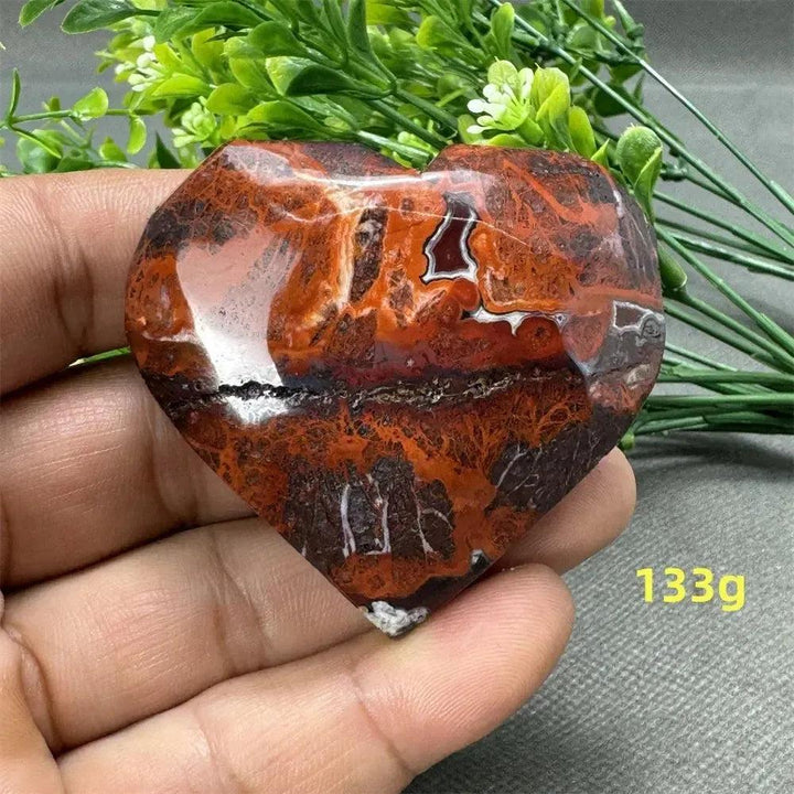 Mesmerizing Mexican Agate heart, 133g, with warm oranges, deep reds, and creamy whites for strength and grounding.