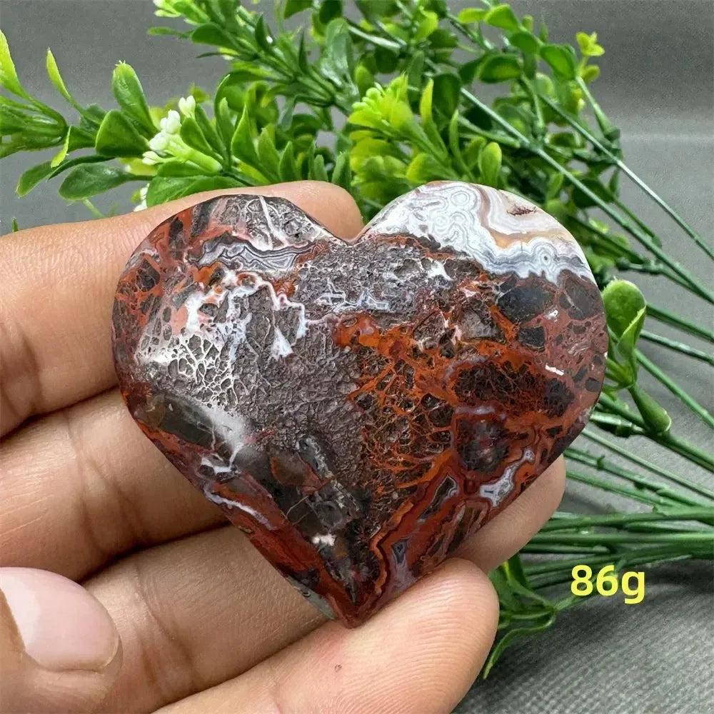 Mesmerizing Mexican Agate heart crystal, 86g, with warm oranges, deep reds, and creamy whites for strength and grounding.