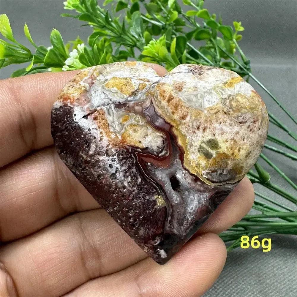 Mexican Agate Crystal Freeform heart, 86g, displaying warm oranges, deep reds, creamy whites, and earthy browns.