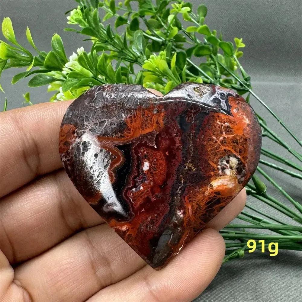 Mesmerizing Mexican Agate heart crystal, 91g, with warm oranges, deep reds, and creamy whites for strength and grounding.