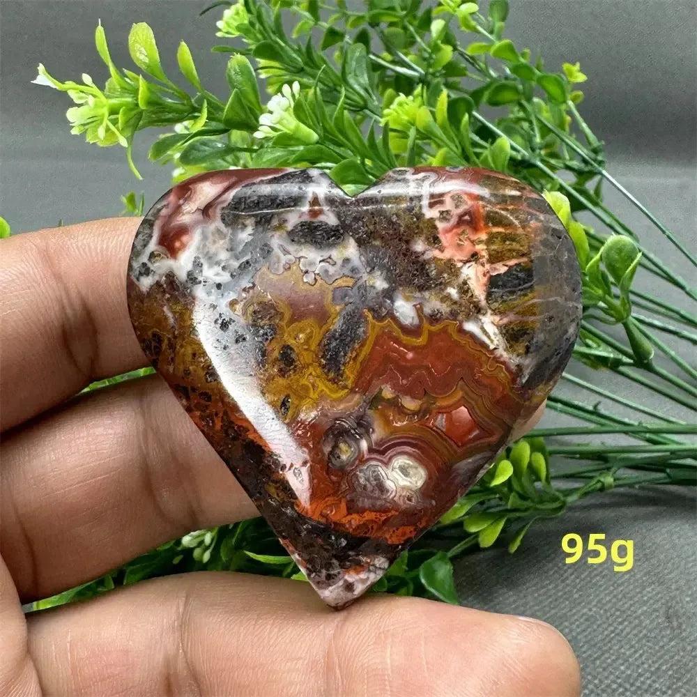 Mesmerizing Mexican Agate heart, 95g, with warm oranges, deep reds, and creamy whites for strength and grounding.