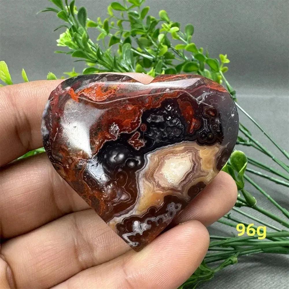 Mesmerizing Mexican Agate Crystal Freeform heart, showcasing warm oranges, deep reds, creamy whites, and earthy browns.