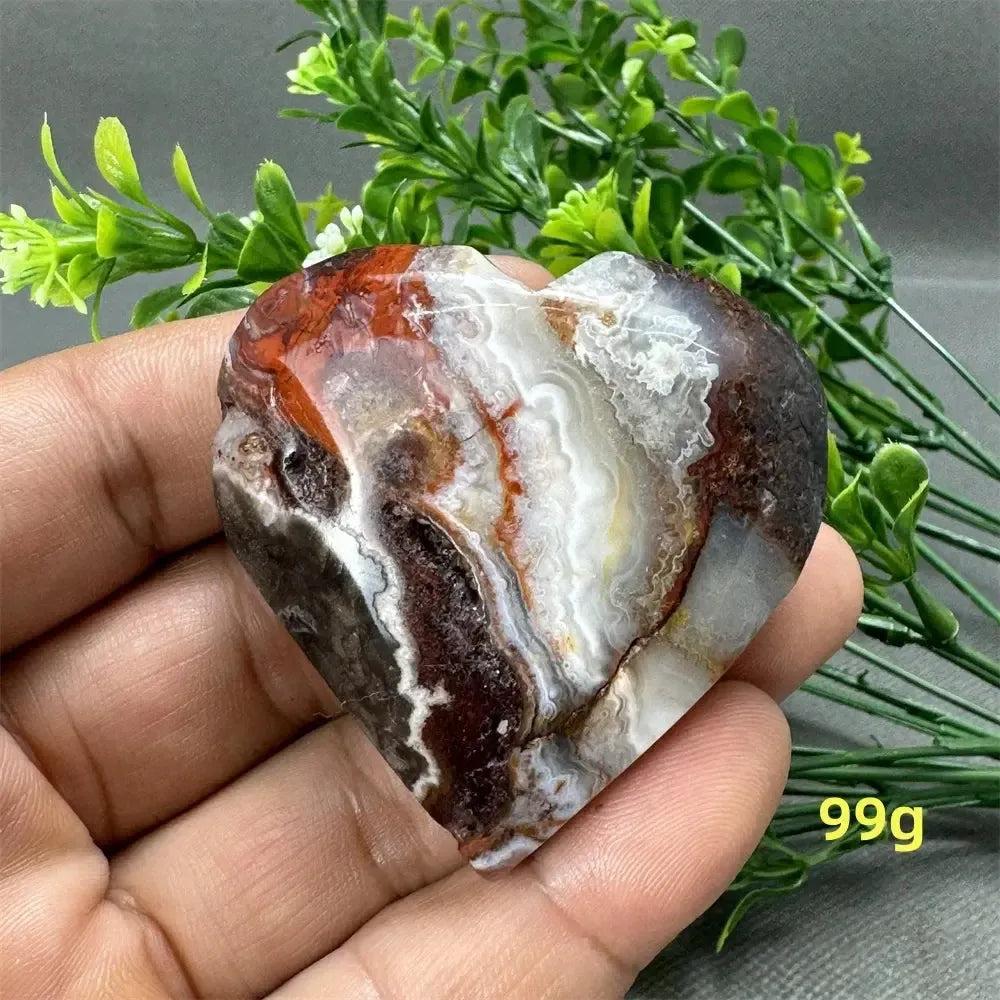 Mexican Agate Crystal Freeform, a heart-shaped stone with warm oranges, deep reds, and creamy whites for strength and grounding.