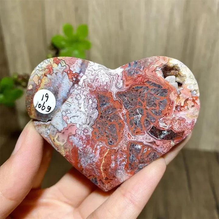 Vibrant Mexican Agate crystal heart for joy & emotional balance, featuring rainbow bands and sparkling druzy interior.