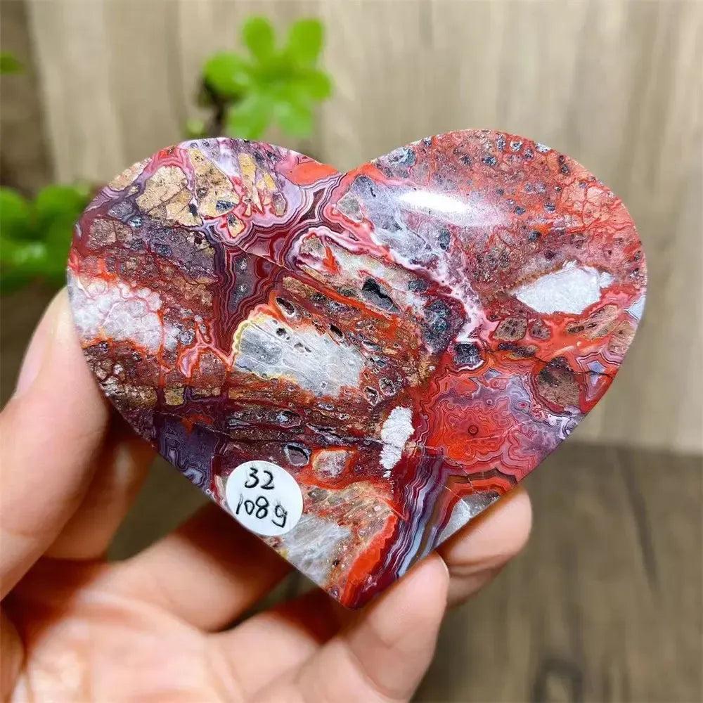 Vibrant Mexican Agate crystal heart for joy & emotional balance, with rainbow bands of pink, purple, orange, red.