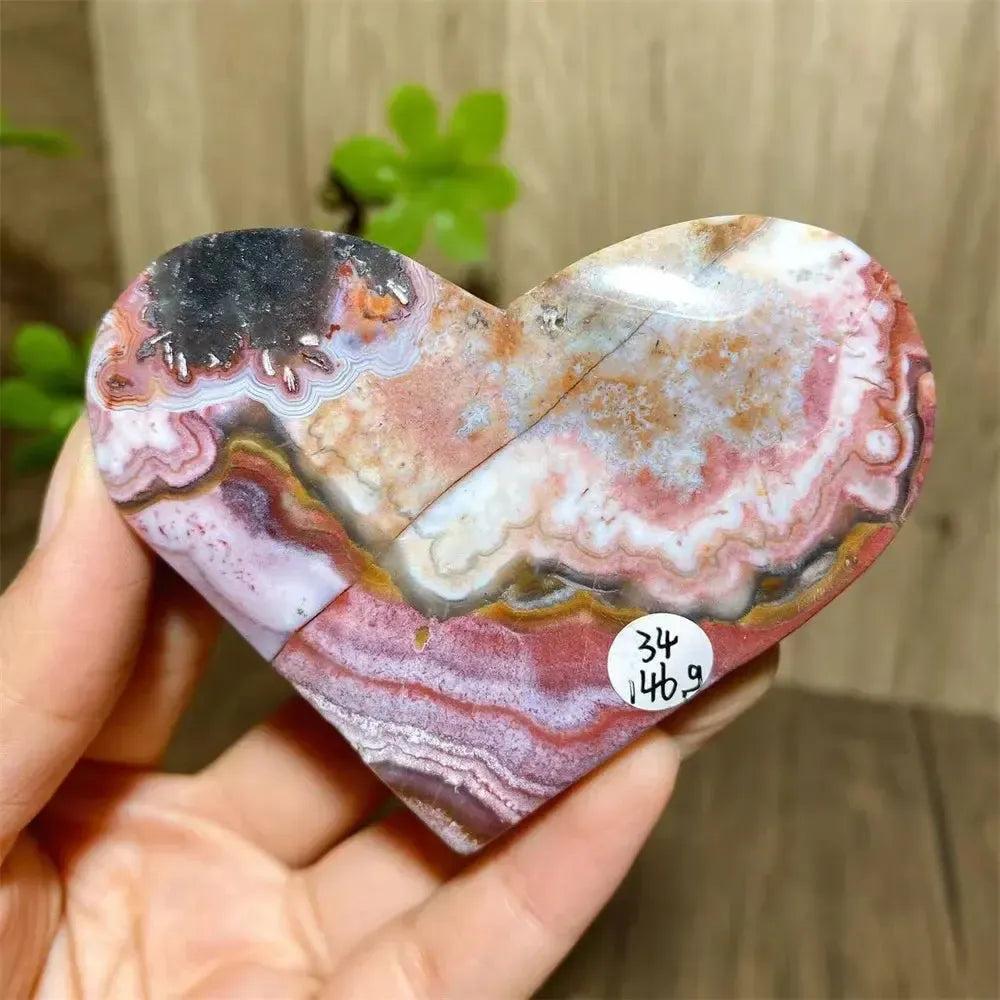 Vibrant Mexican Agate crystal heart, banded in pink, purple, orange, and red, for joy and emotional balance.