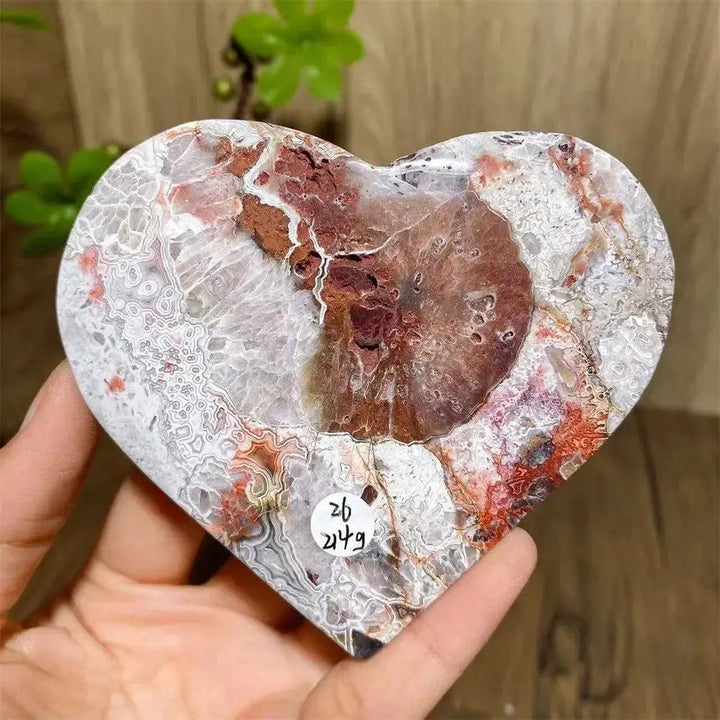 Vibrant Mexican Agate crystal heart with pink, purple, orange, and red bands for joy and emotional balance.