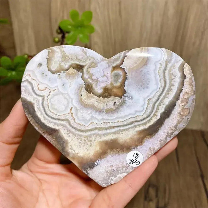 Mexican Agate Crystal Heart for Joy & Emotional Balance. Polished, banded agate heart in pink, purple, orange, yellow, cream, red, and white.