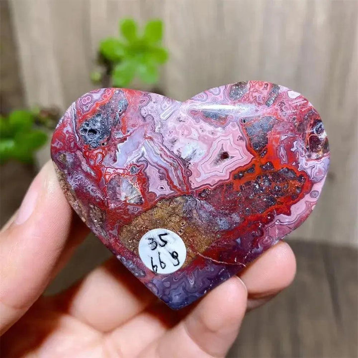 Vibrant Mexican Agate crystal heart for joy & emotional balance, featuring rainbow bands and sparkling druzy interior.