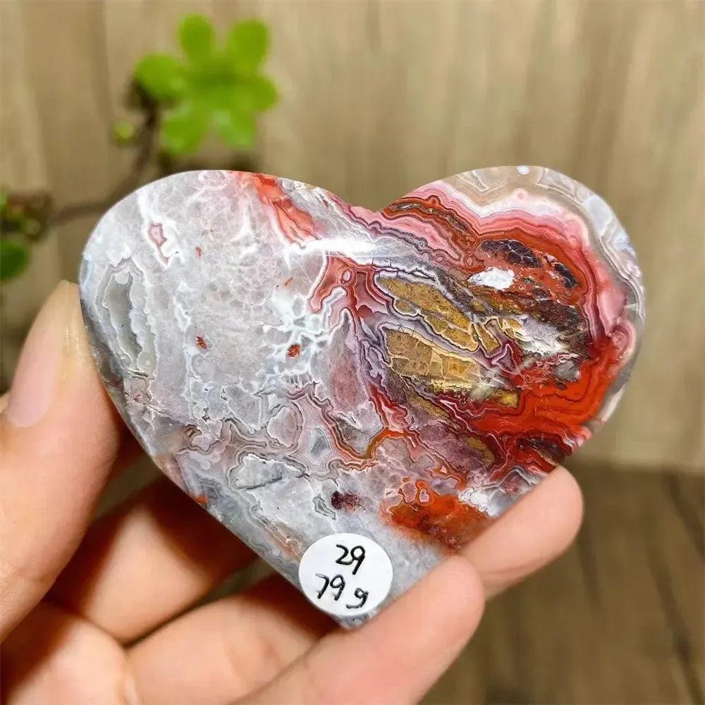 Vibrant Mexican Agate crystal heart, banded in pink, purple, orange, red, and white, for joy and emotional balance.