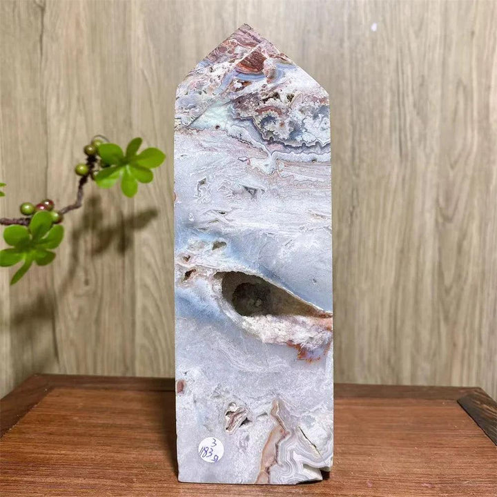 Mexican Agate Crystal Tower: Bold, swirling bands of deep red, cream, and rust with a natural geode opening.