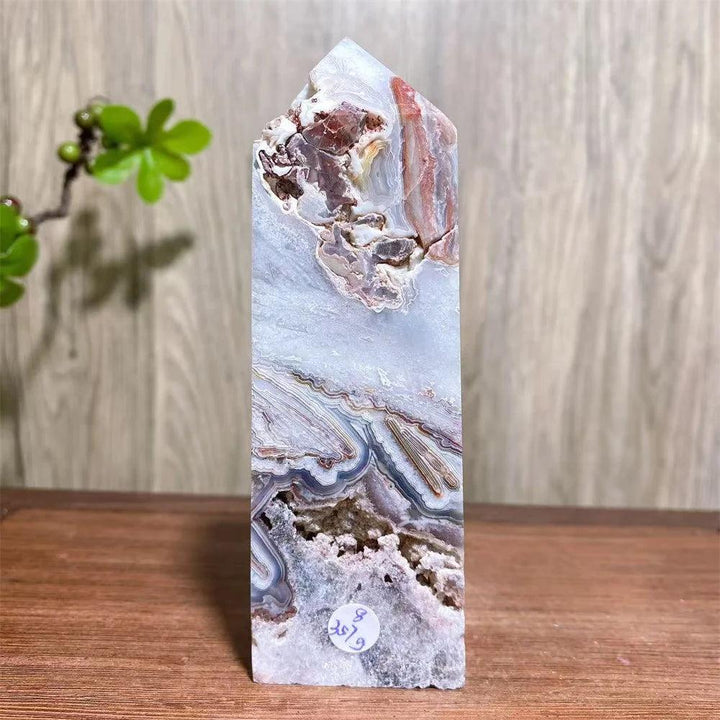 Mexican Agate Crystal Tower: Bold red, cream, rust, and white swirling bands in a natural geode specimen. Grounding & Stability.