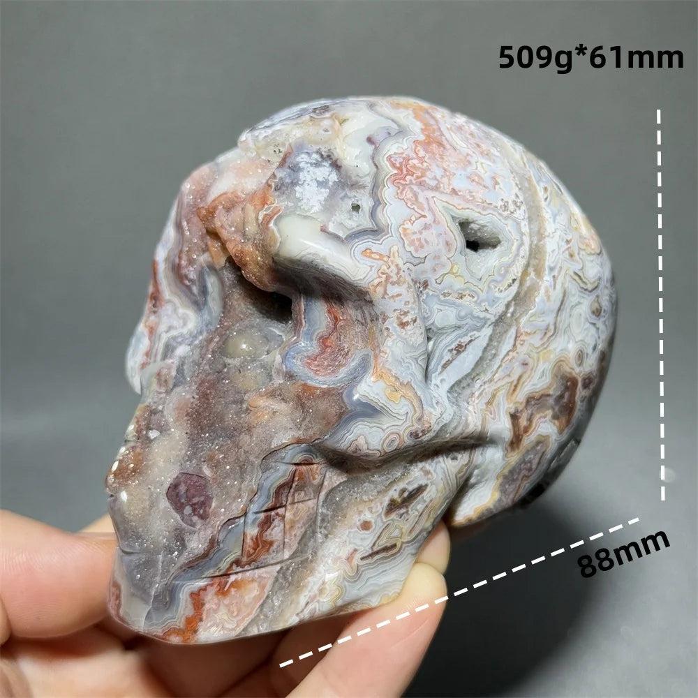 Hand-carved Mexican Agate skull, 88mm, with natural red, white, and grey swirling patterns for healing energy.