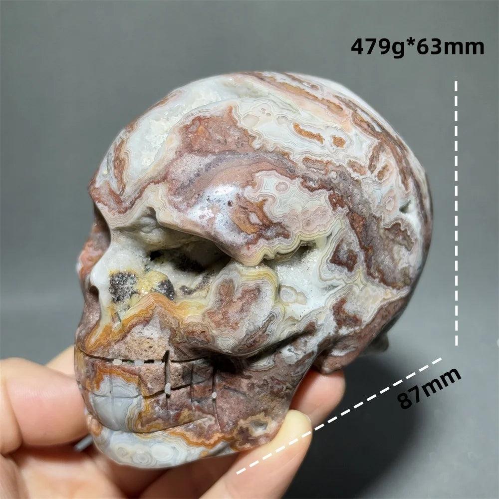 Hand-carved Mexican Agate skull, 87mm, with natural brown, white, and orange swirling patterns, for healing and meditation.