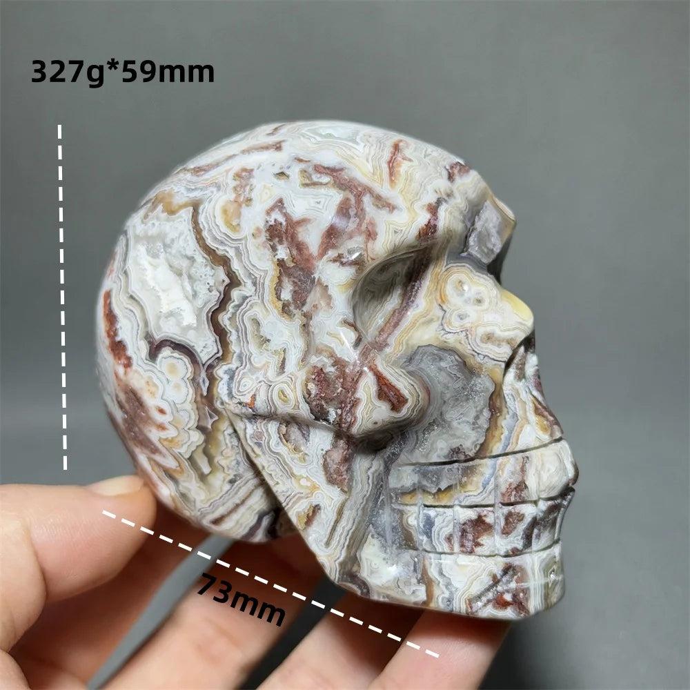 Hand-carved Mexican Agate skull, 327g, 73mm, with natural brown, white, and red swirling patterns for healing energy.