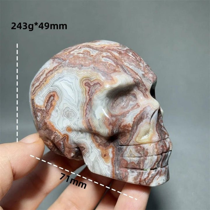 Hand-carved Mexican Agate skull, 71mm, with natural brown, white, and orange swirling patterns, ideal for healing energy.