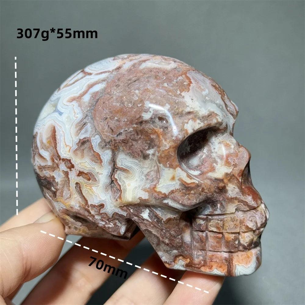 Hand-carved Mexican Agate skull, 70mm, with natural red, white, and brown swirling patterns for healing energy.