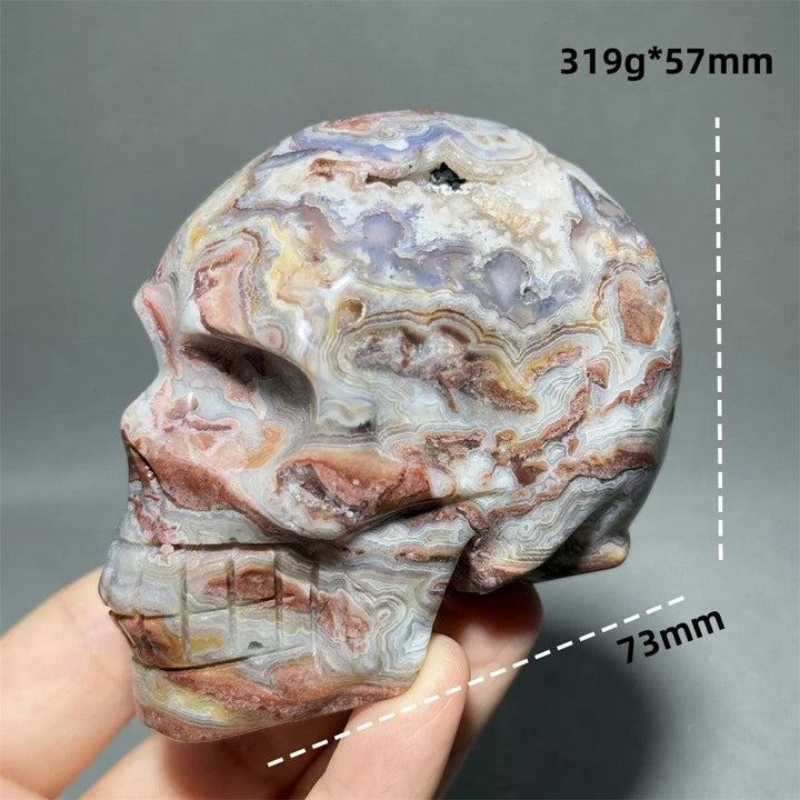 Hand-carved Mexican Agate skull, 73mm, with swirling patterns of red, white, purple, and yellow for healing energy.