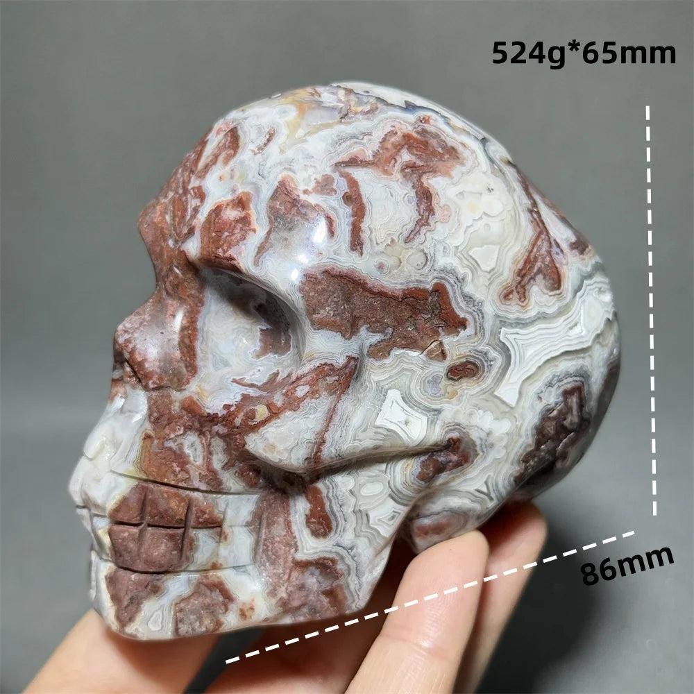 Hand-carved Mexican Agate skull, 524g, 86mm, with natural red, white, and brown swirling patterns for healing energy.