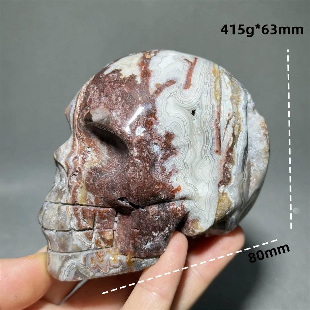 Hand-carved Mexican Agate skull, 80mm, with natural red, white, and brown swirling patterns for healing energy.