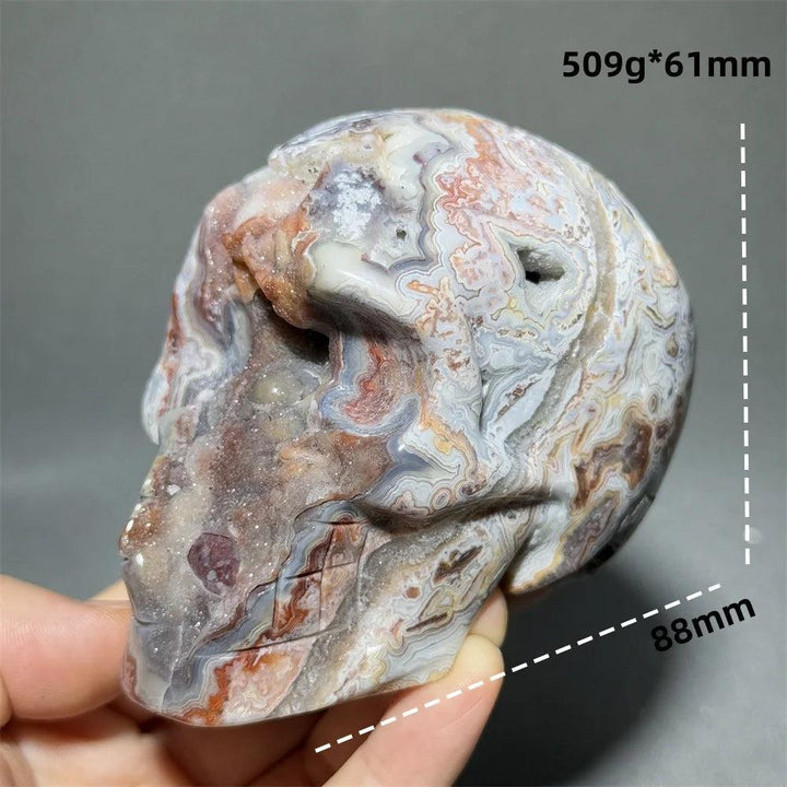 Hand-carved Mexican Agate skull, 88mm, with natural red, white, and grey swirling patterns for healing energy.