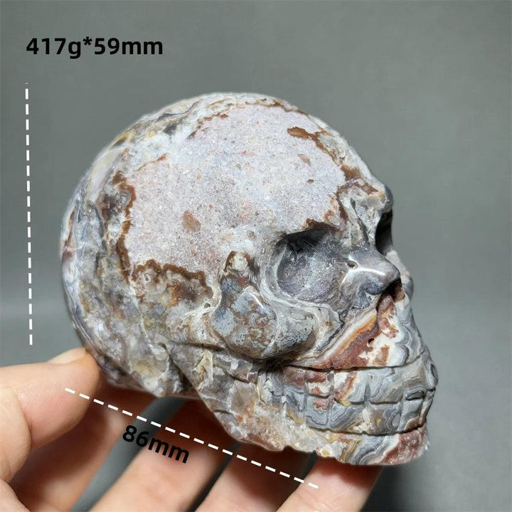 Hand-carved Mexican Agate skull, 86mm, with natural brown, white, and grey patterns for healing energy.