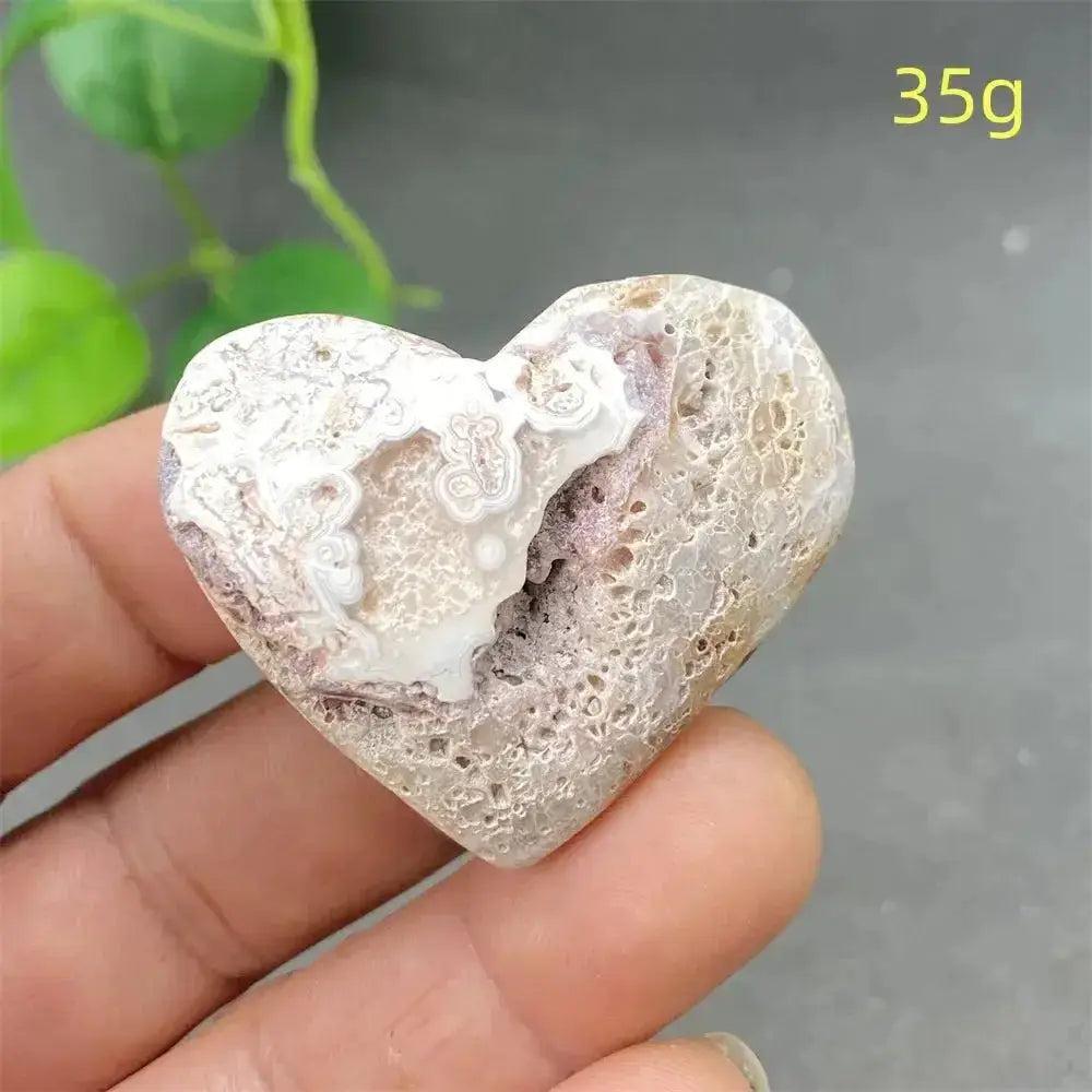 Mexican Striped Agate Crystal Heart, 35g, with warm earthy tones and distinctive parallel striping, held in a hand.