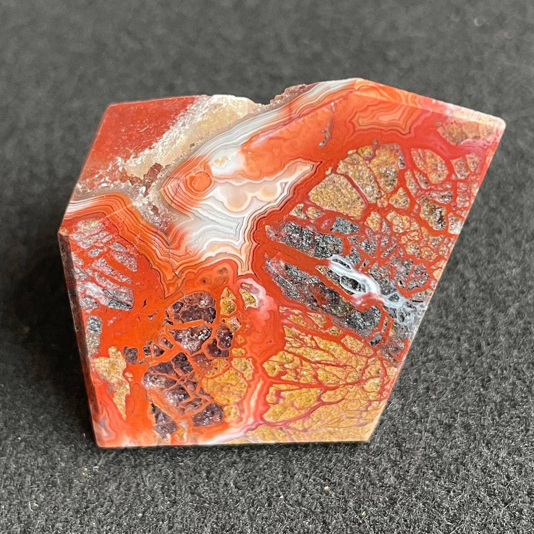 Polished Mexico Agate freeform crystal with vibrant red, orange, and white patterns for Reiki healing and home decor.