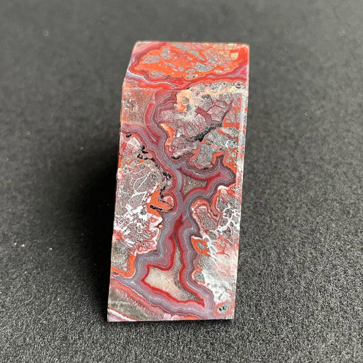 Polished Mexico Agate freeform crystal featuring vibrant red and white banded patterns for healing and home decor.