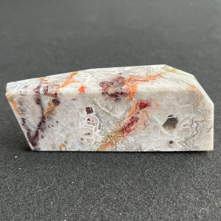 Polished Mexico Agate freeform crystal featuring vibrant red carnelian patterns and intricate white banding for healing.