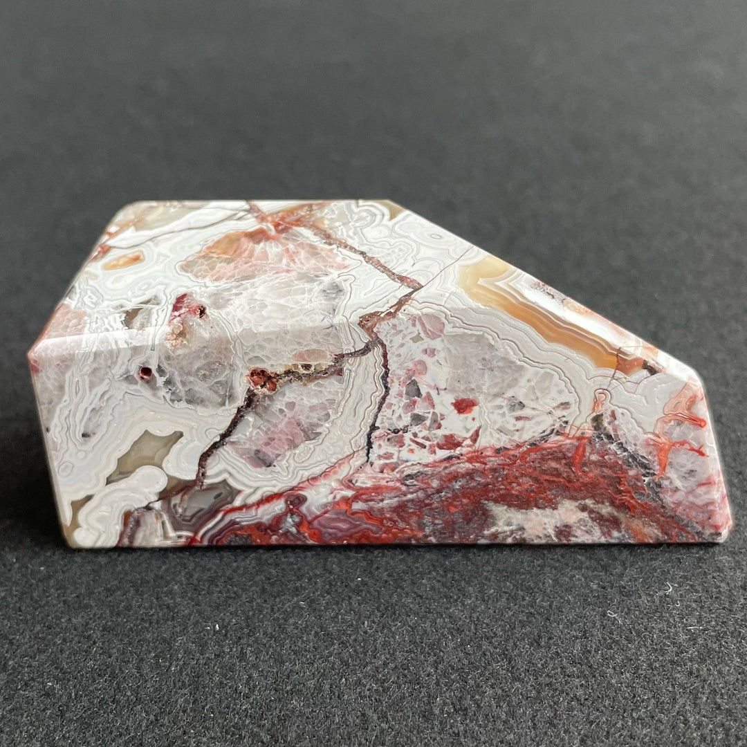 Polished Mexico Agate freeform crystal with vibrant red carnelian patterns and intricate white banding for Reiki healing.