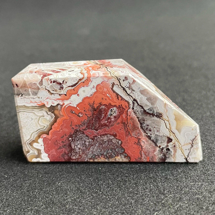 Polished Mexico Agate freeform crystal featuring vibrant red and white banded patterns, perfect for Reiki healing decor.