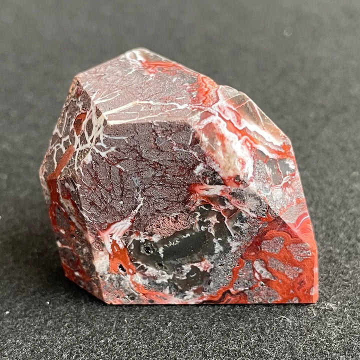 Polished Mexico Agate freeform crystal featuring vibrant red and grey patterns, perfect for Reiki healing and decor.