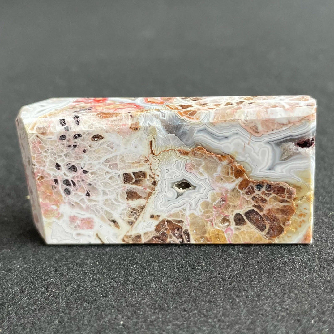 Polished Mexico Agate freeform crystal with intricate banded patterns, earthy tones, and healing energy for home decor.