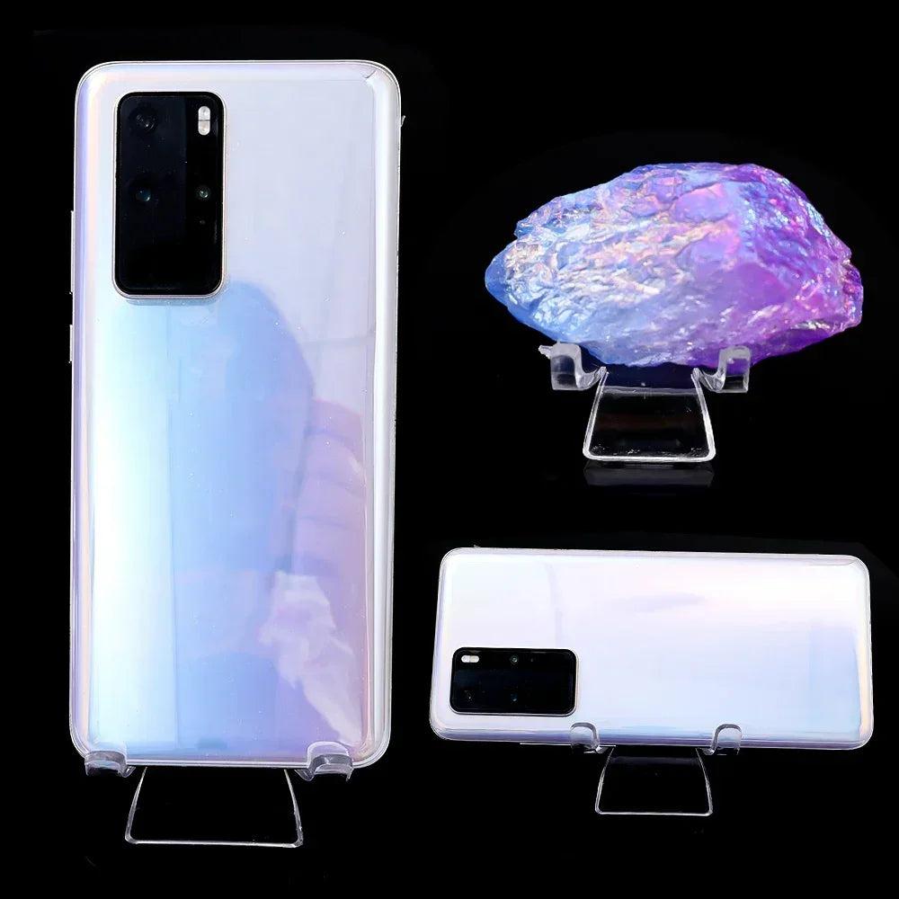 Clear acrylic easel stands displaying a phone and a vibrant purple crystal cluster.