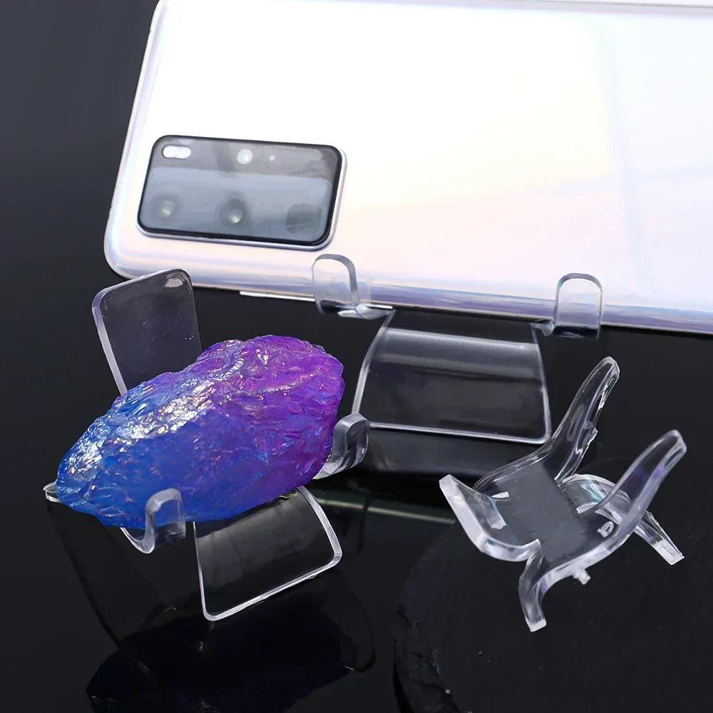 Clear acrylic easel stands displaying a vibrant blue and purple crystal specimen.