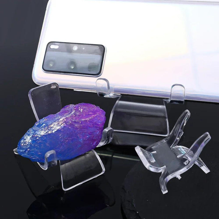 Clear acrylic easel stands displaying a vibrant blue and purple crystal specimen.