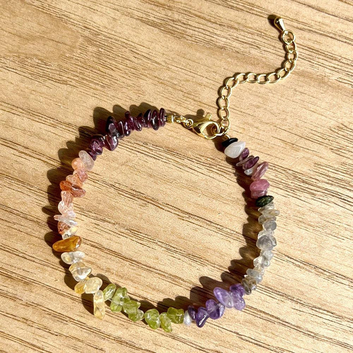 Bohemian Mixed Gemstone Crystal Chip Chakra Bracelet with Garnet, Amethyst, and Peridot, featuring a gold lobster clasp.