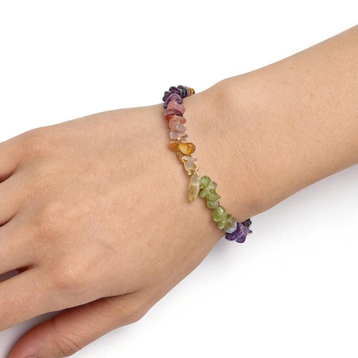 Bohemian Mixed Gemstone Crystal Chip Chakra Bracelet with Garnet, Amethyst, and Peridot, worn on a wrist.