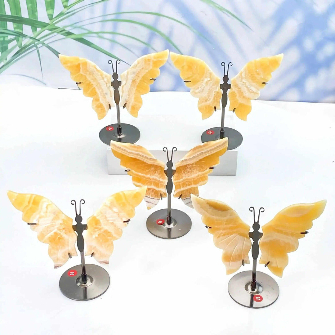 Yellow Calcite crystal butterfly carvings on metal stands, perfect for Solar Plexus Chakra energy and graceful decor.