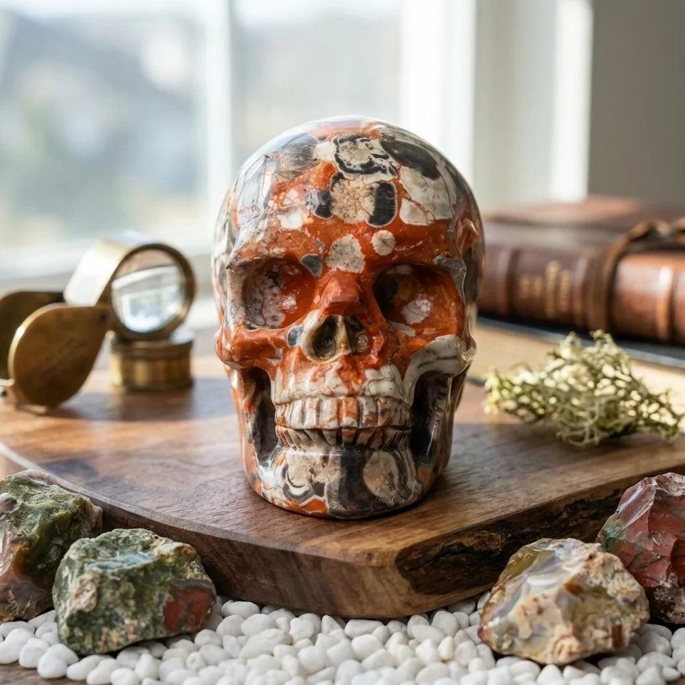 Natural Crystal Skull Money Agate carving with vibrant red and black patterns, perfect for healing energy and decor.