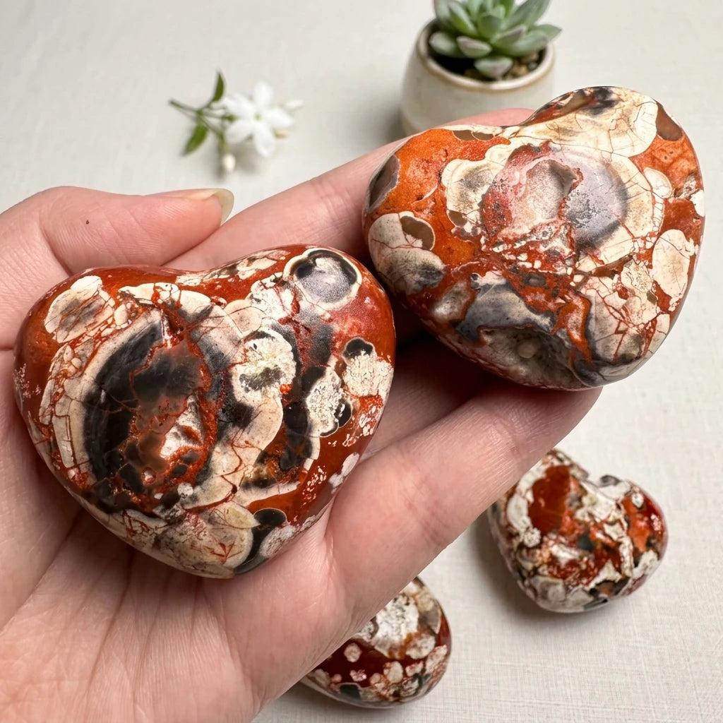Polished Natural Money Agate heart crystal with vibrant red, white, and black patterns for elegant home decor and healing.