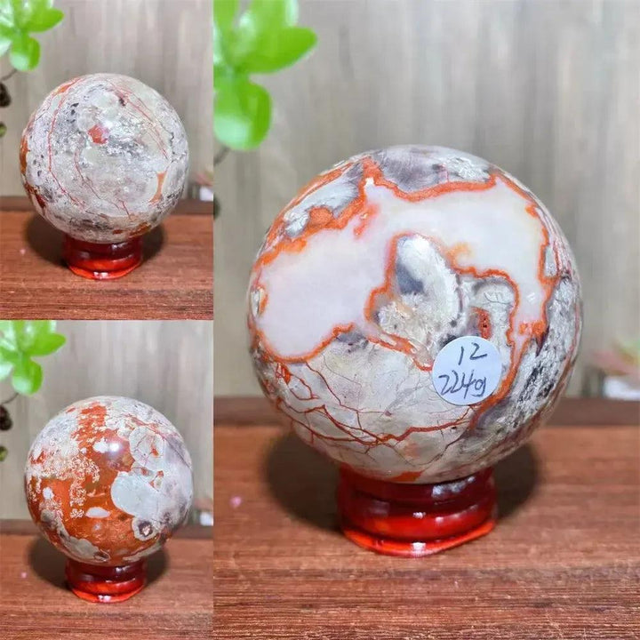 Polished Money Agate Crystal Sphere with vibrant gold, rust, cream, and warm brown banding on a red stand.