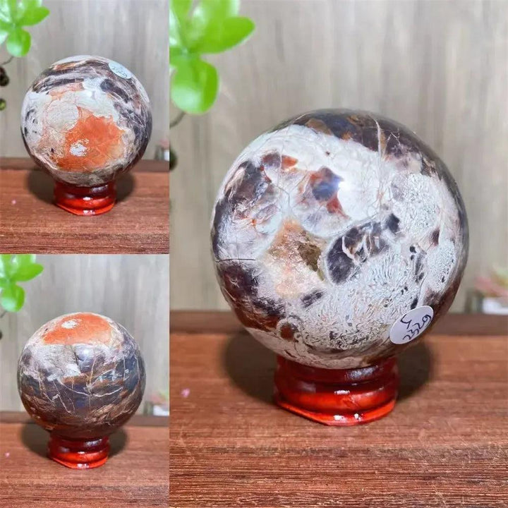 Polished Money Agate Crystal Sphere with vibrant gold, rust, cream, and warm brown banding on a red wooden stand.