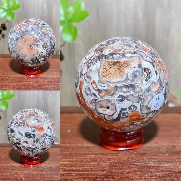 Polished Money Agate Crystal Sphere, a unique abundance stone with vibrant gold, rust, and cream banding on a red stand.