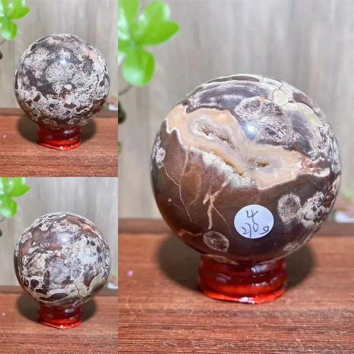 Money Agate Crystal Sphere: Polished abundance stone with rich gold, rust, cream, and warm brown banding on a red stand.